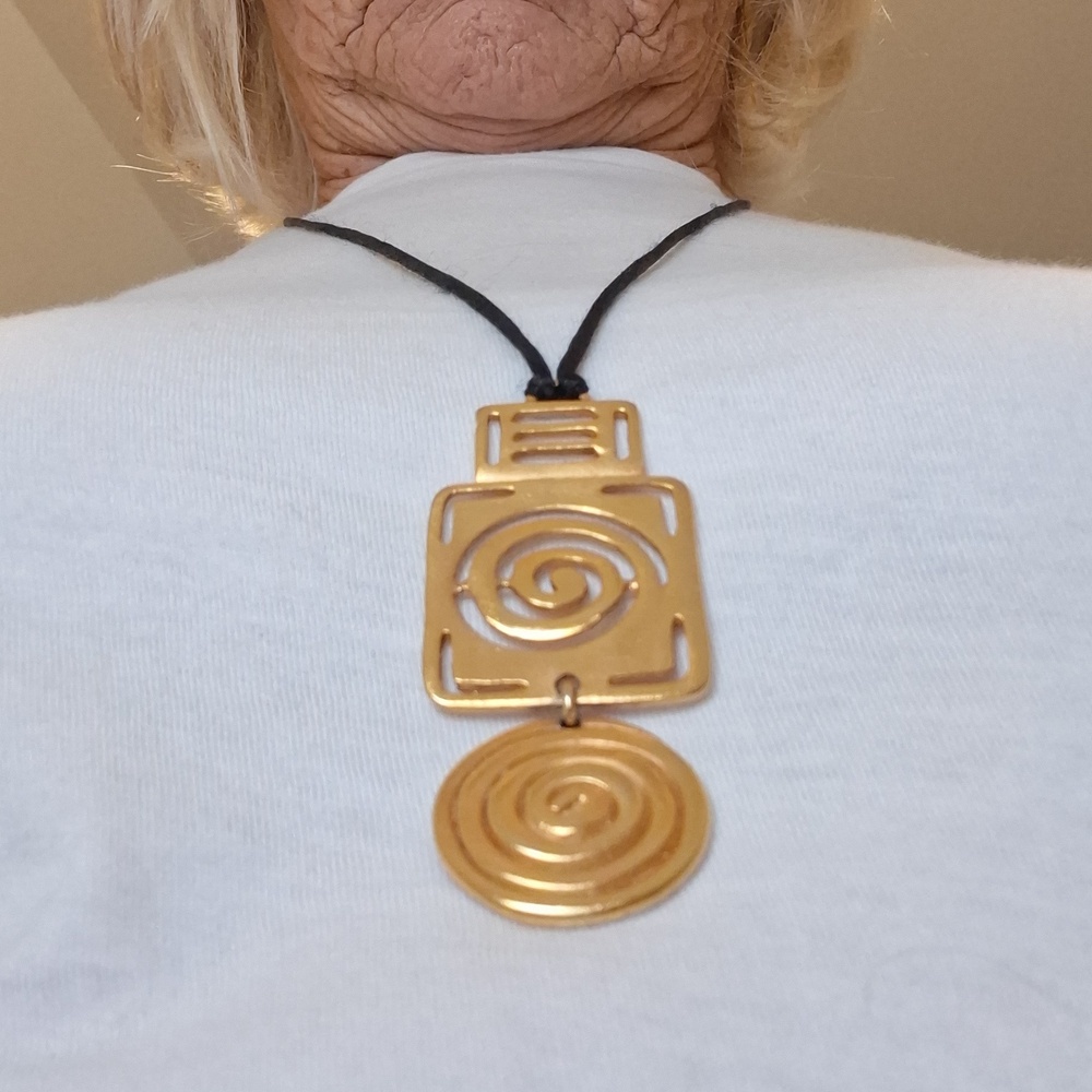 Gold tone, stacked geometric pendant on a 15" black cord